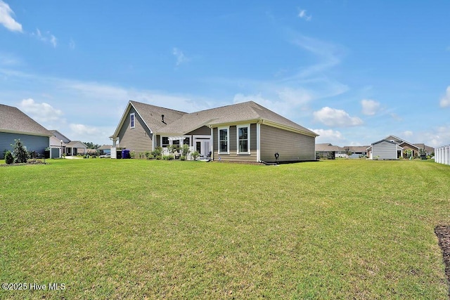 back of property with a lawn