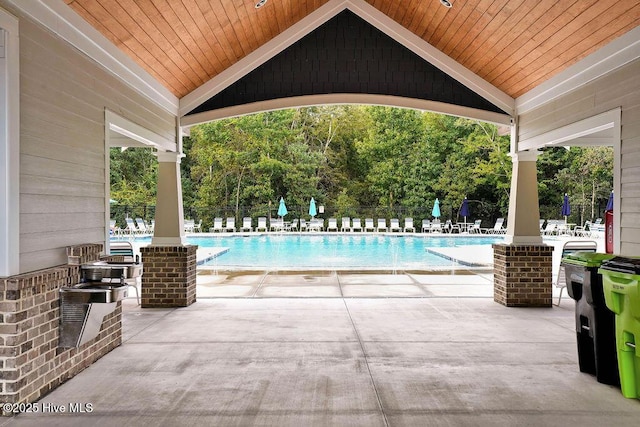 community pool featuring a patio and fence