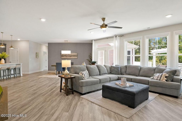 living area with ceiling fan, light wood finished floors, baseboards, and recessed lighting