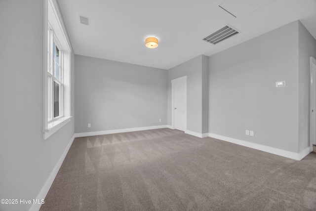 empty room featuring carpet flooring and baseboards