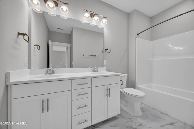bathroom featuring marble look tile flooring, toilet, double vanity, and washtub / shower combination