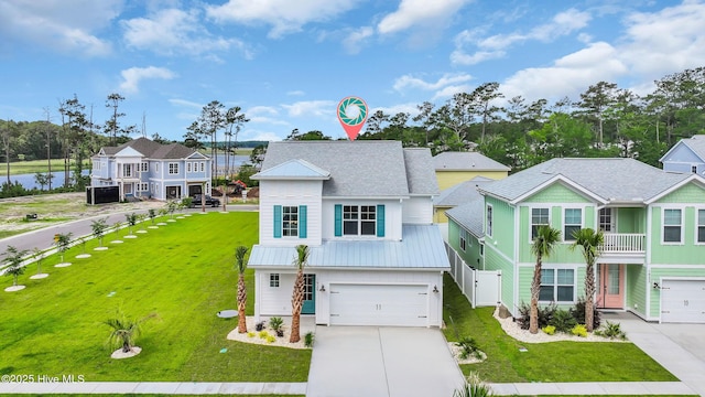 view of front of property with concrete driveway, a garage, and a front yard