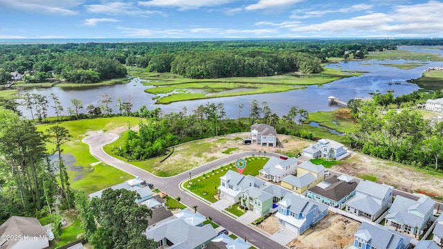 aerial view of residential area featuring a large body of water