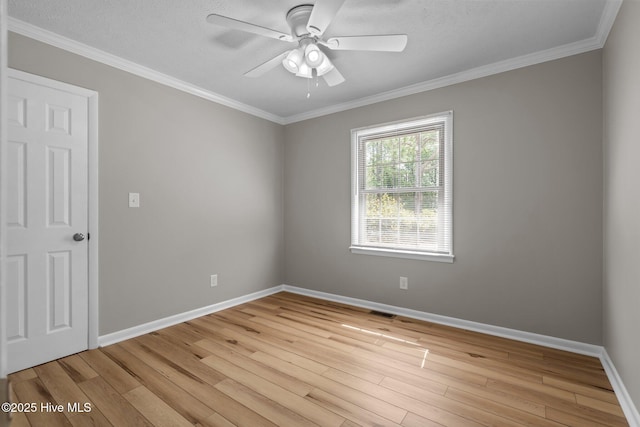 spare room featuring light wood finished floors, baseboards, ornamental molding, and ceiling fan
