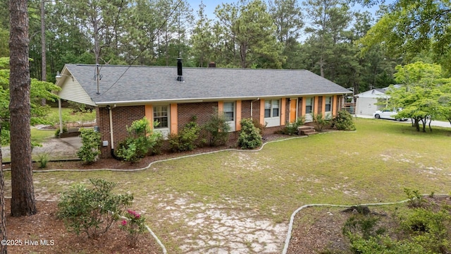 ranch-style house featuring brick siding, roof with shingles, a front lawn, and view of scattered trees
