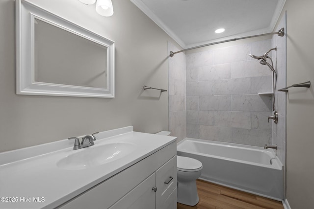 bathroom with wood finished floors, toilet, crown molding, vanity, and  shower combination
