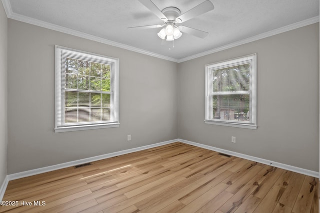 empty room featuring light wood-style flooring, crown molding, baseboards, and a ceiling fan