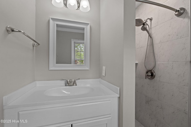 bathroom featuring a tile shower and vanity