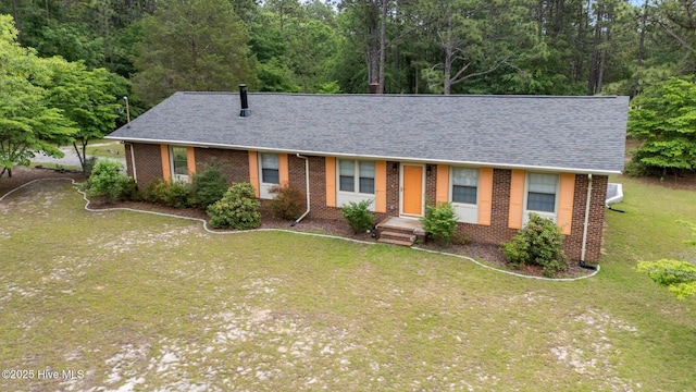 ranch-style house with a shingled roof, brick siding, and a front yard