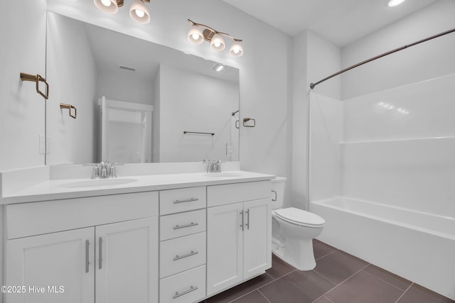 full bath featuring toilet, double vanity, shower / bathtub combination, and tile patterned floors