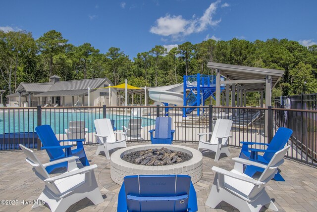 160 Freedom Park Rd, Beaufort, NC 28516 - view of patio featuring a fire pit, fence, a community pool, and view of scattered trees