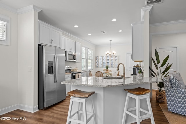 160 Freedom Park Rd, Beaufort, NC 28516 - kitchen featuring stainless steel appliances, a sink, a breakfast bar area, dark wood finished floors, and crown molding