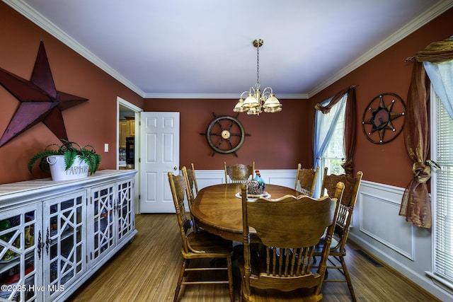1992 Acorn Dr, New Bern, NC 28562 - dining area featuring a chandelier, ornamental molding, a wainscoted wall, and wood finished floors