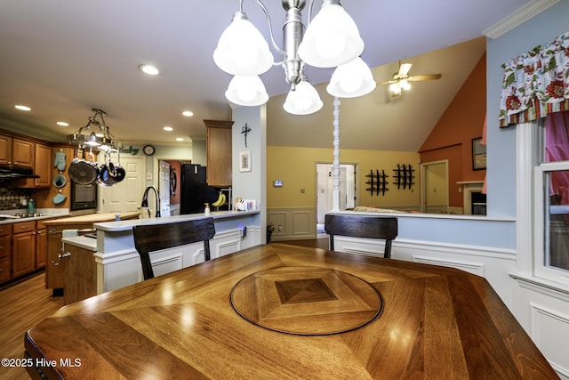 1992 Acorn Dr, New Bern, NC 28562 - dining room with a chandelier, a decorative wall, a wainscoted wall, recessed lighting, and lofted ceiling