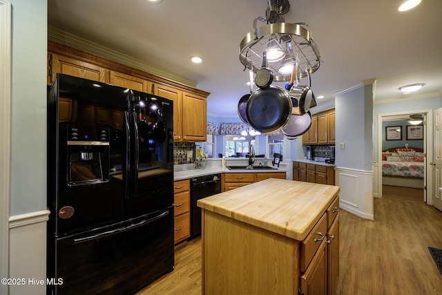 1992 Acorn Dr, New Bern, NC 28562 - kitchen with black appliances, wooden counters, ornamental molding, a kitchen island, and decorative backsplash