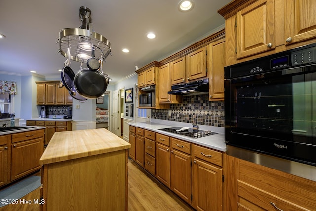 1992 Acorn Dr, New Bern, NC 28562 - kitchen with black appliances, crown molding, wood counters, decorative backsplash, and under cabinet range hood