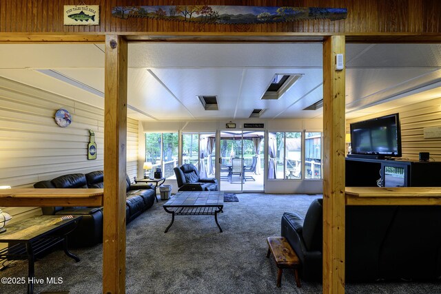 1992 Acorn Dr, New Bern, NC 28562 - carpeted living area with healthy amount of natural light and wooden walls