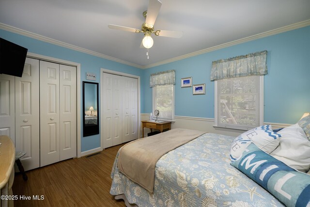 1992 Acorn Dr, New Bern, NC 28562 - bedroom featuring multiple closets, multiple windows, wood finished floors, ornamental molding, and a ceiling fan