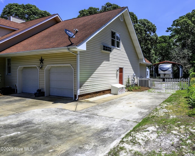1992 Acorn Dr, New Bern, NC 28562 - view of property exterior with driveway, roof with shingles, and an attached garage