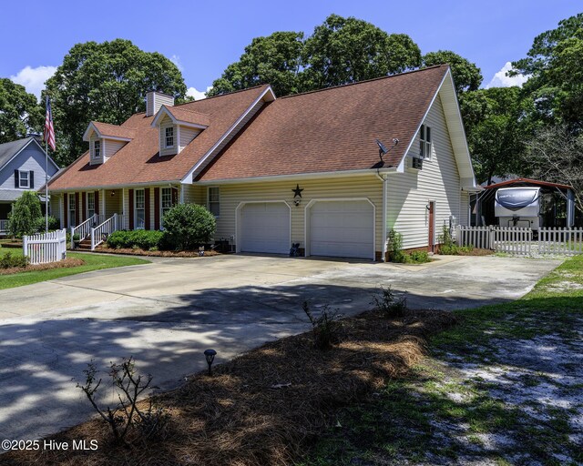 1992 Acorn Dr, New Bern, NC 28562 - new england style home with a chimney, an attached garage, driveway, roof with shingles, and covered porch