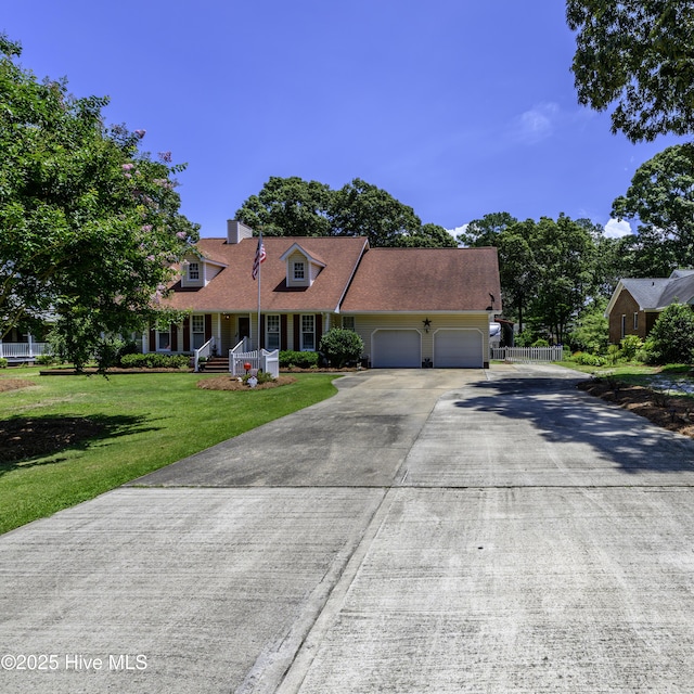 1992 Acorn Dr, New Bern, NC 28562 - cape cod house featuring a garage, a front lawn, covered porch, driveway, and a chimney