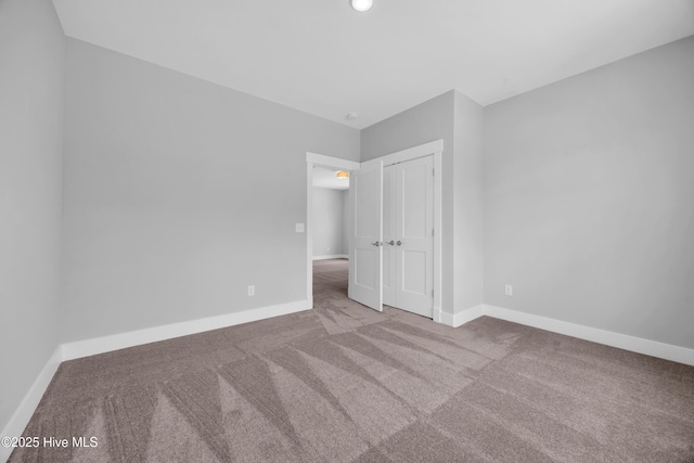 unfurnished bedroom with carpet floors, baseboards, a closet, and recessed lighting