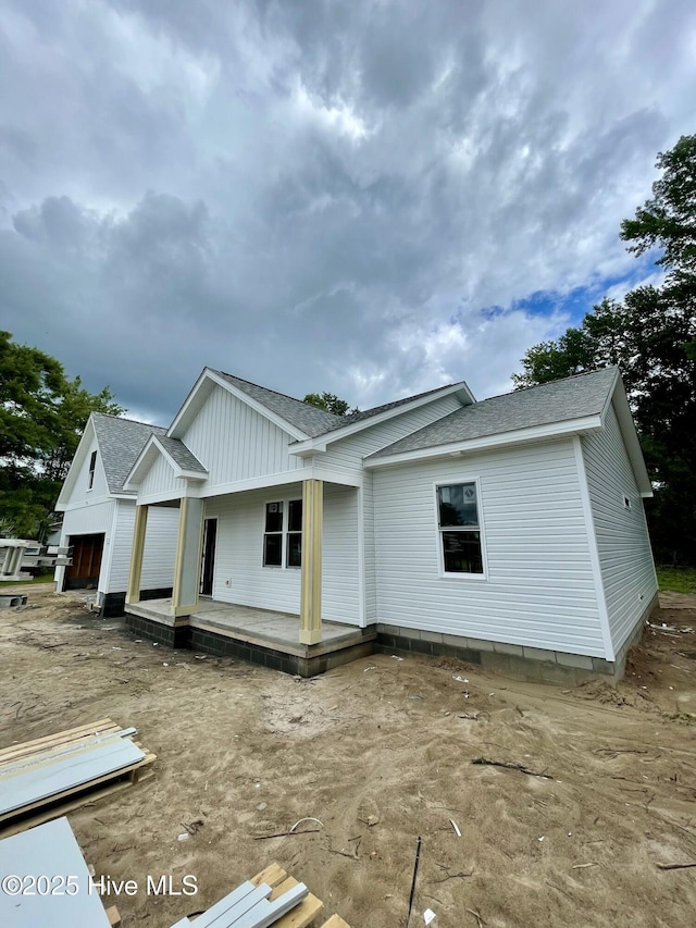 169 Howard Rd, Newport, NC 28570 - view of front facade with roof with shingles, covered porch, and board and batten siding