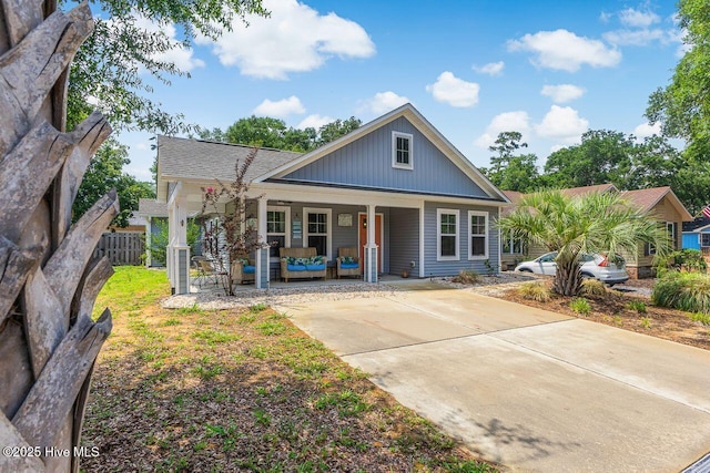 227 NE 38th St, Oak Island, NC 28465 - view of front of house featuring a porch