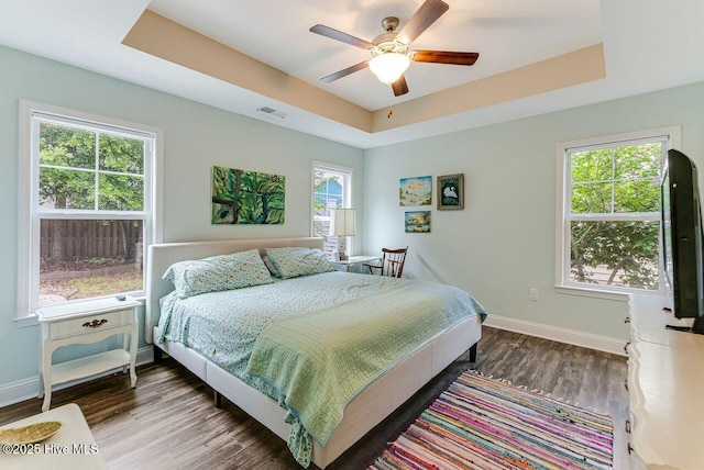 227 NE 38th St, Oak Island, NC 28465 - bedroom with a raised ceiling, wood finished floors, and ceiling fan