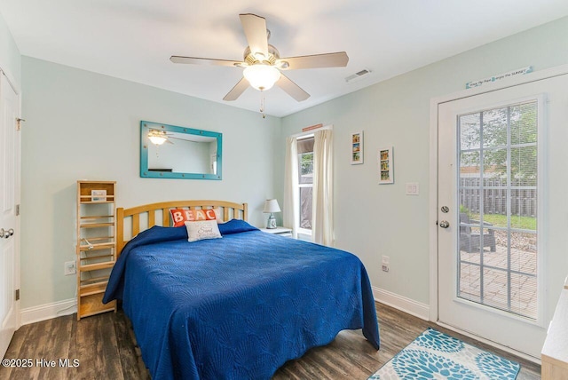 227 NE 38th St, Oak Island, NC 28465 - bedroom featuring multiple windows, wood finished floors, and access to outside