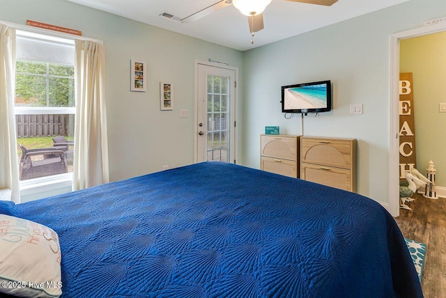 227 NE 38th St, Oak Island, NC 28465 - bedroom featuring access to exterior, wood finished floors, and ceiling fan