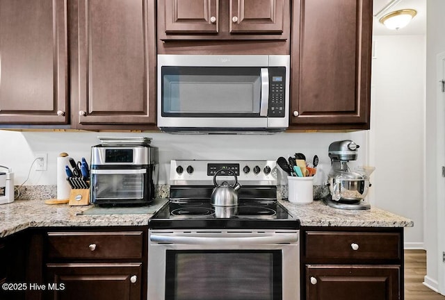 1807 St Patricks Ct SE Lot 267, Bolivia, NC 28422 - kitchen featuring appliances with stainless steel finishes, dark brown cabinets, and wood finished floors