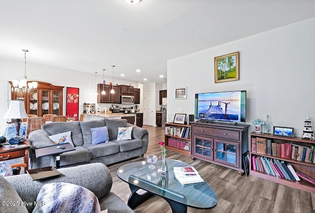 1807 St Patricks Ct SE Lot 267, Bolivia, NC 28422 - living room featuring a chandelier, wood finished floors, and recessed lighting