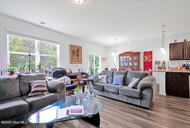 1807 St Patricks Ct SE Lot 267, Bolivia, NC 28422 - living room featuring wood finished floors and a chandelier