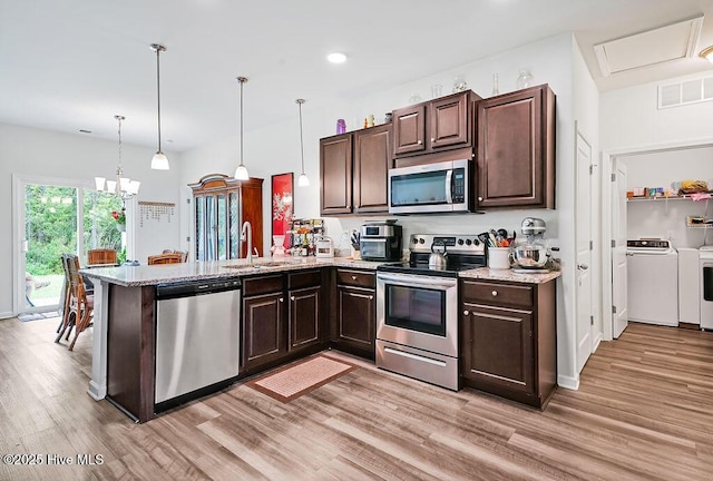 1807 St Patricks Ct SE Lot 267, Bolivia, NC 28422 - kitchen featuring stainless steel appliances, a sink, dark brown cabinetry, light wood finished floors, and recessed lighting