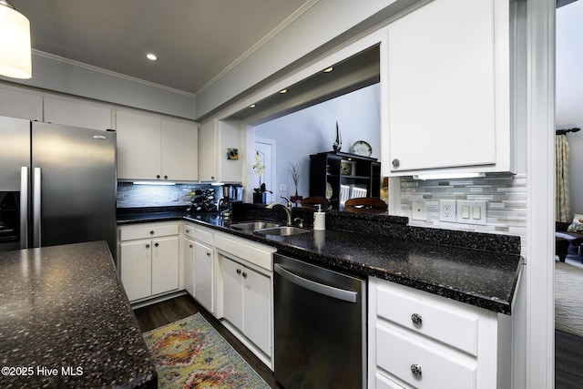 302 Plantation Dr, New Bern, NC 28562 - kitchen with appliances with stainless steel finishes, a sink, crown molding, dark wood-type flooring, and white cabinets