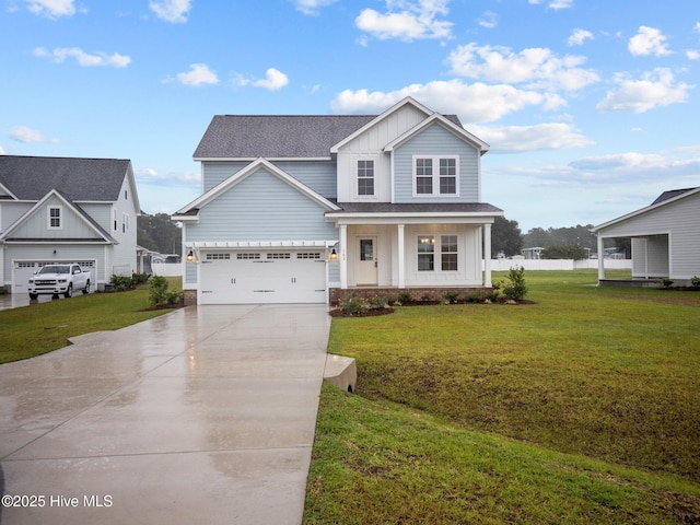 206 Ethan Pl, Hubert, NC 28539 - view of front of house with board and batten siding, concrete driveway, roof with shingles, a front lawn, and covered porch