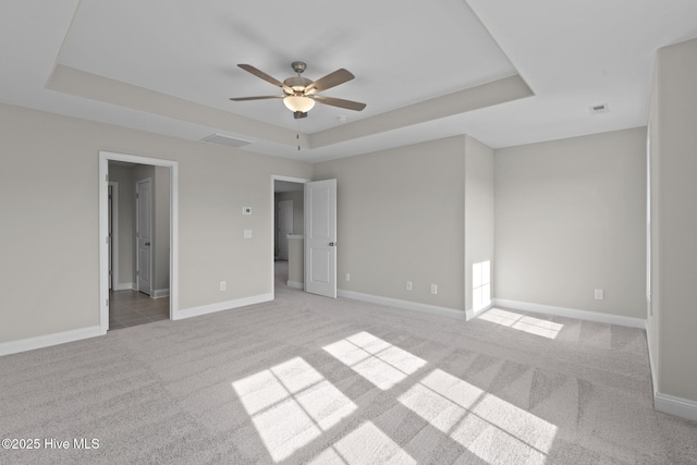 206 Ethan Pl, Hubert, NC 28539 - unfurnished bedroom featuring a raised ceiling, light colored carpet, baseboards, and a ceiling fan