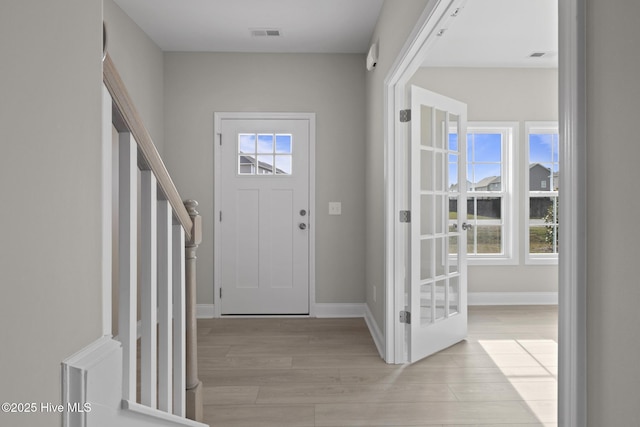 206 Ethan Pl, Hubert, NC 28539 - foyer entrance featuring light wood-style floors, plenty of natural light, and baseboards