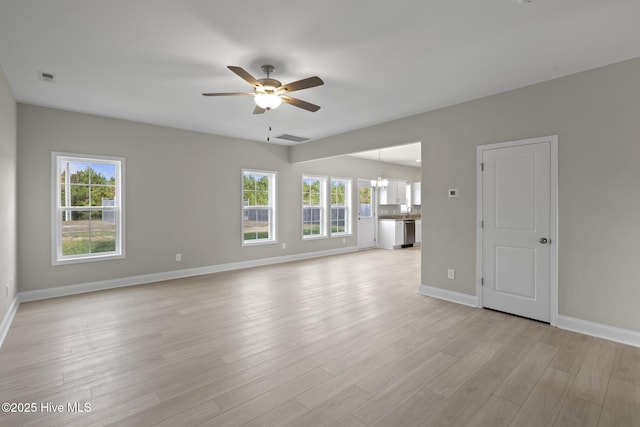 206 Ethan Pl, Hubert, NC 28539 - unfurnished living room with a ceiling fan, light wood-style flooring, baseboards, and a chandelier