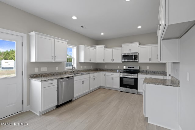 206 Ethan Pl, Hubert, NC 28539 - kitchen with appliances with stainless steel finishes, a sink, light stone countertops, light wood-style floors, and recessed lighting