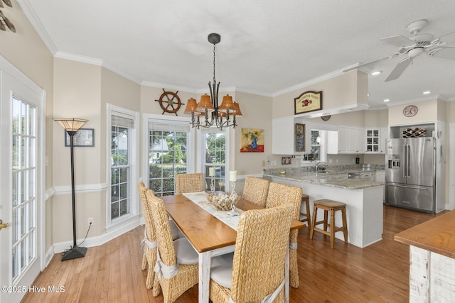 109 Lobster Ln, Emerald Isle, NC 28594 - dining room with wood finished floors, crown molding, a chandelier, recessed lighting, and a ceiling fan