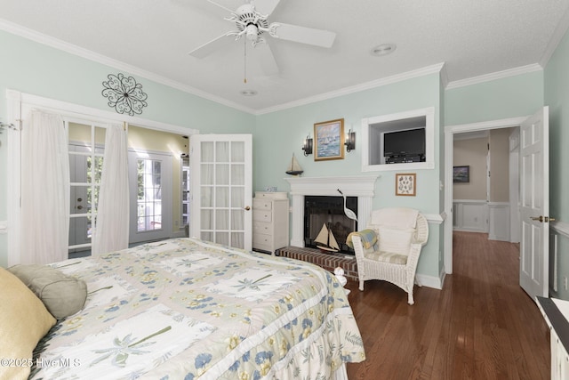 109 Lobster Ln, Emerald Isle, NC 28594 - bedroom featuring ornamental molding, wood finished floors, a fireplace, wainscoting, and ceiling fan