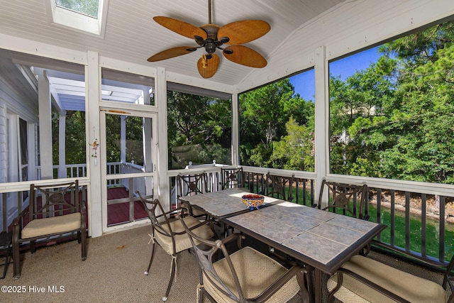 109 Lobster Ln, Emerald Isle, NC 28594 - sunroom with ceiling fan, outdoor dining area, lofted ceiling, a skylight, and view of scattered trees