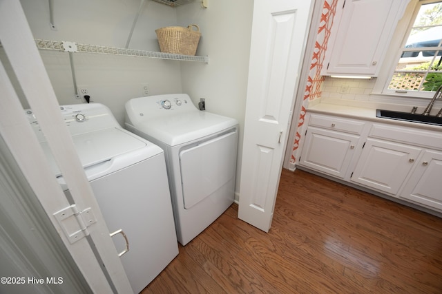 clothes washing area with light wood-style flooring and washing machine and dryer