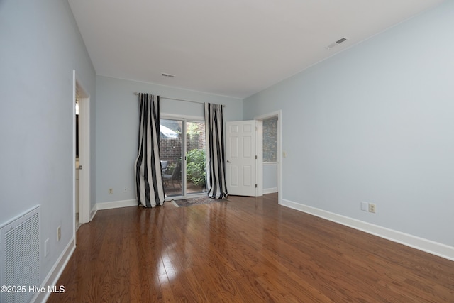empty room featuring wood finished floors and baseboards
