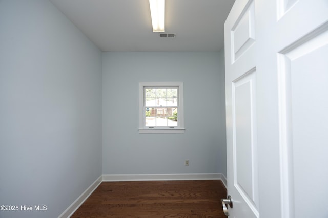 unfurnished room with wood finished floors and baseboards