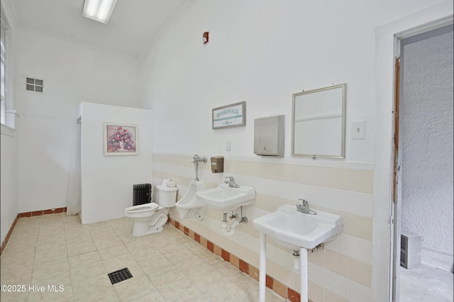 9291 NC-171, Williamston, NC 27892 - bathroom featuring radiator heating unit, a sink, toilet, and tile patterned floors