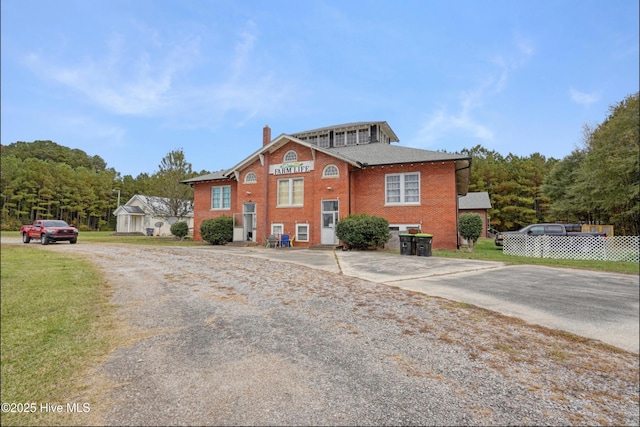 9291 NC-171, Williamston, NC 27892 - view of front of home with brick siding, driveway, a chimney, and a front lawn
