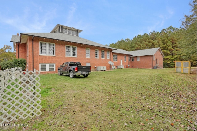 9291 NC-171, Williamston, NC 27892 - rear view of house with brick siding, a yard, and roof with shingles